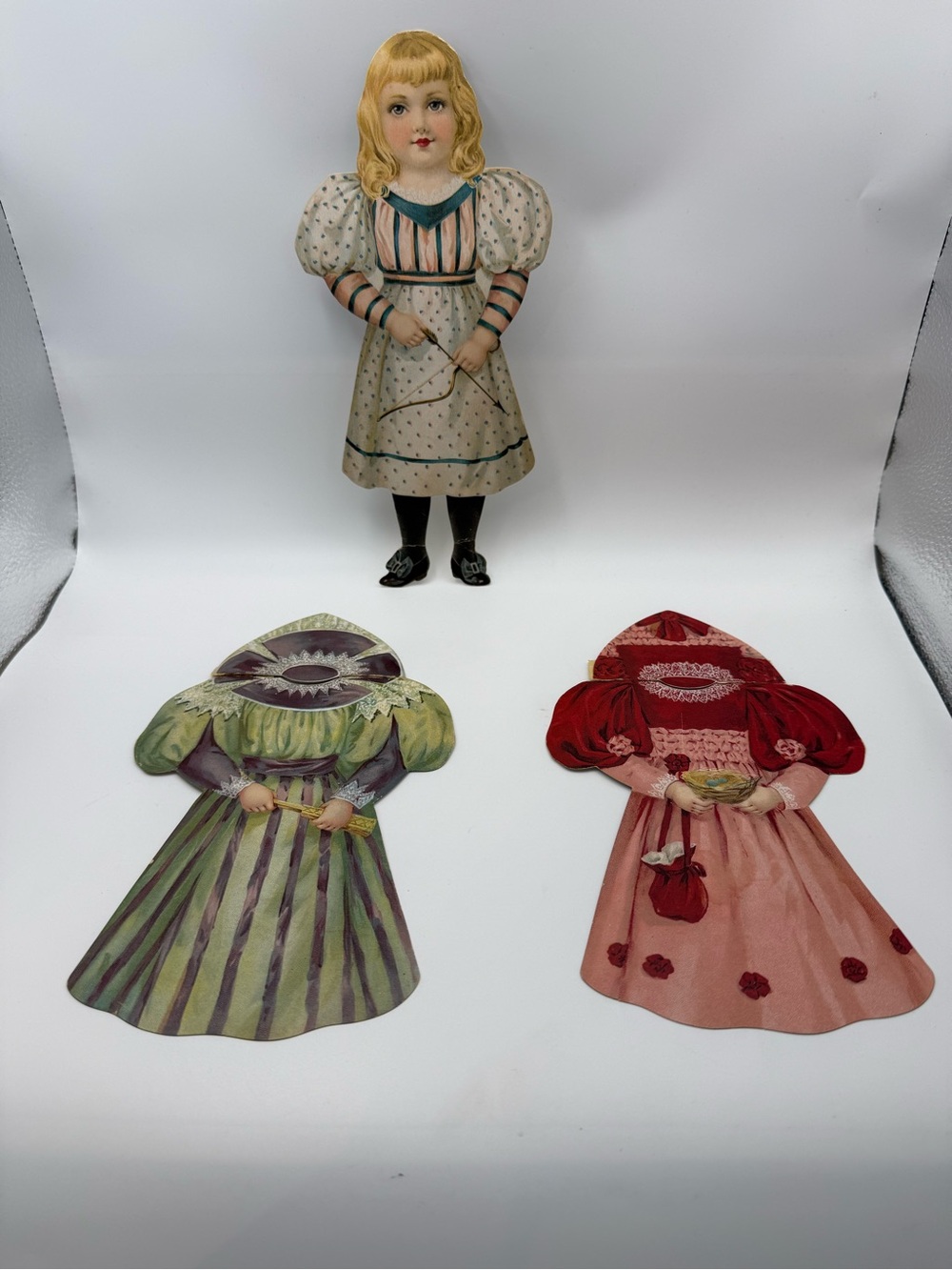 Antique Victorian Lithograph
Die Cut Paper Doll Blonde Girl Bow Arrow Wardrobe